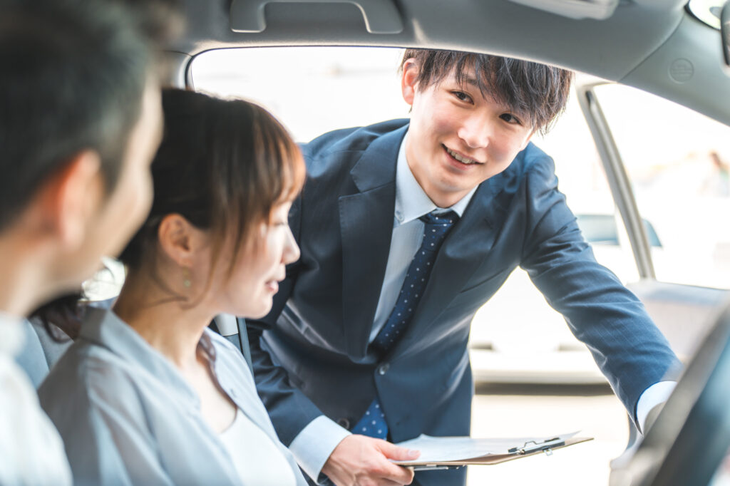車の販売をするスーツの男性