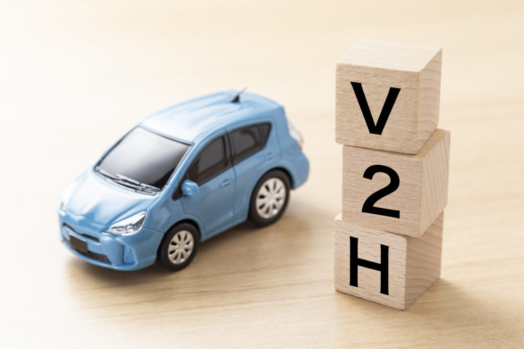 「V2H」と書かれたブロックとエコカー